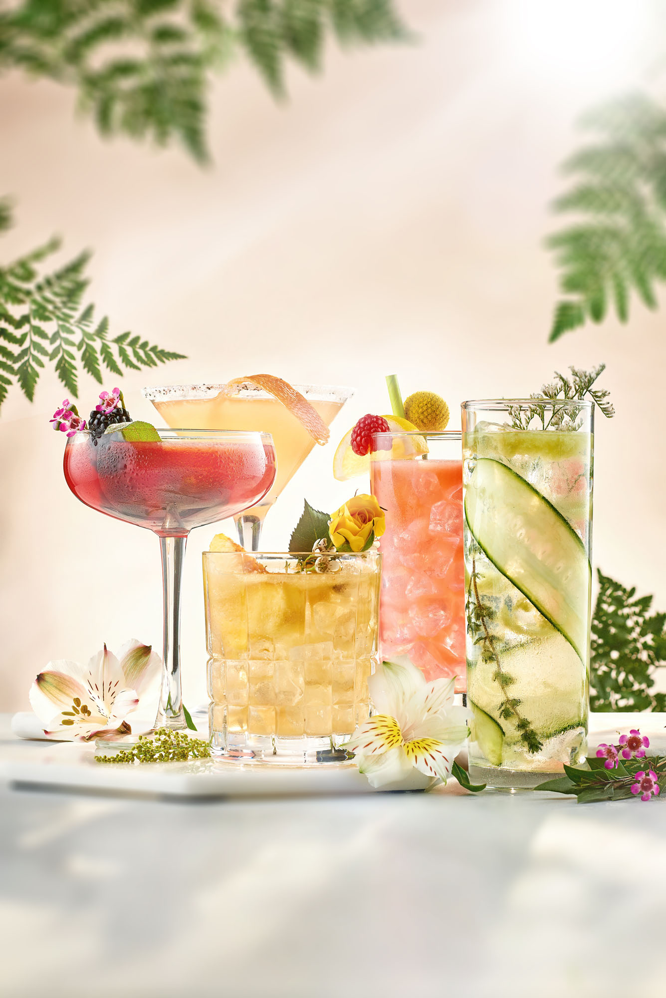 5 different decorated cocktails resting on a table.